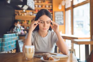 Woman with Painful Fibromyalgia Headache Watches Her Diet Because Coffee & Processed Croissant Act as Triggers | Vitacost.com/blog