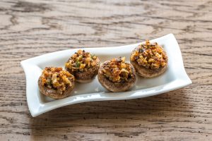 Stuffed mushrooms with bacon and cheez on white plate | Vitacost.com/blog