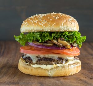 Close Up of a Stacked Mushroom Swiss Burger #Recipe on Wood Table | Vitacost.com/blog