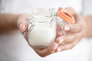 Woman Holding Mason Jar Filled with DIY After-Sun Skincare Treatment | Vitacost.com/Blog