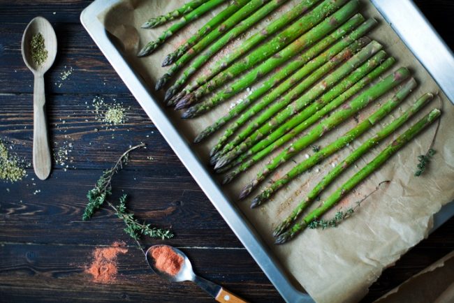 Baking Pan With a Bunch of Roasted Asparagus on Wood Table #recipe | Vitacost.com/blog