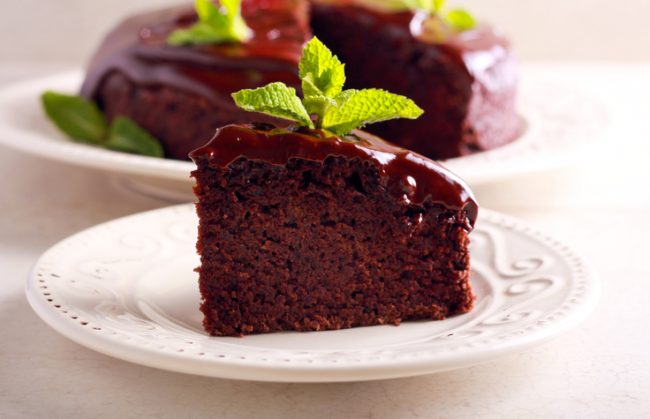 Slice of Paleo Chocolate Cake with Chocolate Icing on White Plate | Vitacost.com/blog