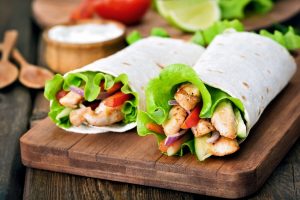 2 Chicken Burrito Wraps With Lettuce & Red Bell Pepper on Cutting Board #recipe | Vitacost.com/blog