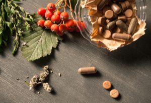 Cluster of Berries, Natural Herbs and Supplements for Stress Relief Arranged on Dark Wooden Table | Vitacost.com/blog