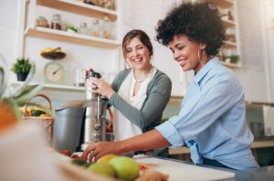 Health Coach Teaching Woman How to Make Fresh Fruit Smoothie in Kitchen | Vitacost.com/blog