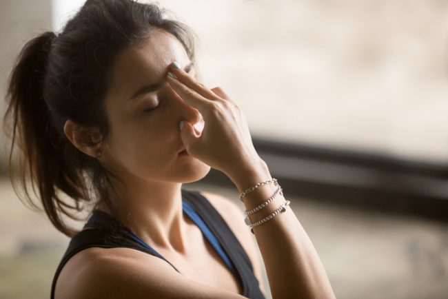 Woman Practicing Alternate Nostril Breathing Yogic Breath to Boost Mood | Vitacost.com/Blog