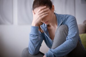 Woman in Need of Migraine Relief Holding Head in Pain | Vitacost.com/blog