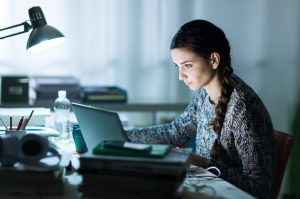 Young Woman Enjoying the Benefits of Meditation Focusing on Work on Laptop Computer | Vitacost.com/blog
