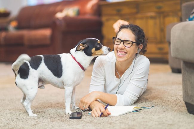 Woman Journaling With Dog on the Floor Beats Negativity Bias & Knows How to Create Positivity in Your Life | Vitacost.com/blog