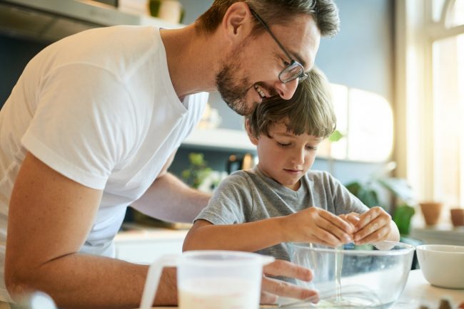 Man With Glasses Helps His Son Make Eggs, One of the Top Superfoods for Men’s Health | Vitacost.com/blog