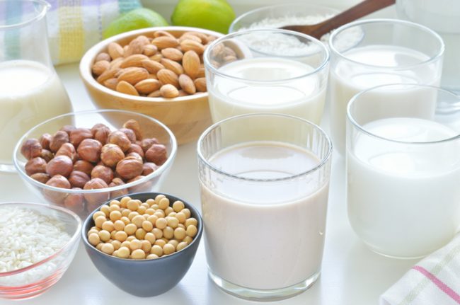 Assortment of Dairy Substitutes Such as Soy Milk and Almond Milk Lined up on Table | Vitacost.com/blog