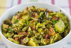 Shaved Brussels Sprouts and Bacon in Bowl With Blurred Background | Vitacost Blog