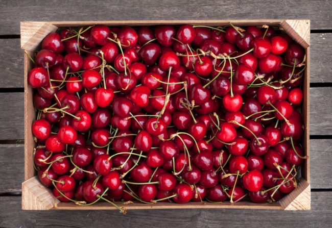 Crate Packed with Ripe, Red Cherries to Represent Fresh Fruits and Vegetables of Summer | Vitacost.com/blog