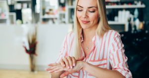 Woman Moisturizing and Exfoliating Hands to Look Younger | Vitacost.com/Blog