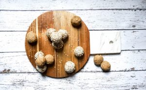 Overhead of Cutting Board With Tahini Protein Bites on Wood Table #recipe | Vitacost