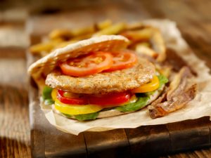 Turkey Burger With Tomato, Peppers and Lettuce on Wood Block | Vitacost Blog