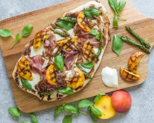Grilled Flatbread Peach Pizza With Prosciutto, Mozzarella & Basil on Cutting Board #recipes | Vitacost.com/blog