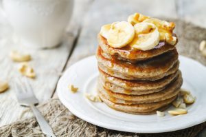 Stack of Pancakes Topped With Nuts and Bananas | Vitacost Blog