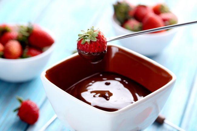 Strawberry Being Dipped into Small Bowl of Magic Chocolate Shell | Vitacost.com/blog
