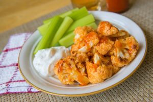 Buffalo Cauliflower on Plate with Vegan Ranch & Celery