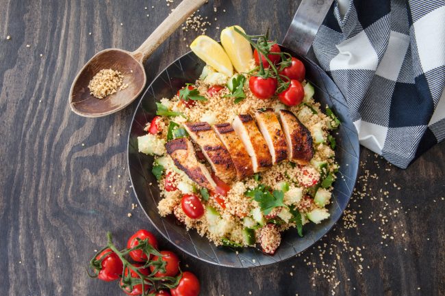 Sliced Chicken on Couscous with Tomatoes on Rustic Background | Vitacost Blog