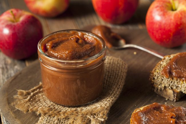 Slow Cooker Apple Butter Apple Butter In a Jar Surrounded by Red Apples | Vitacost Blog