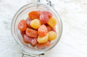 Colorful Assortment of Gummy Vitamins for Adults in Glass Jar on White Table | Vitacost.com/blog