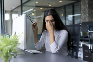 Woman Affected by Chronic Stress Effects Suffering from a Sinus Headache Holding Head in Pain | Vitacost Blog