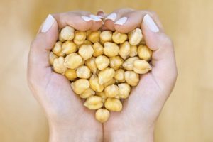 Hands Holding Chickpeas in Heart Shape Representing Green Living Goal of Improving Soil Health With a Soil-Friendly Diet | Vitacost.com/blog