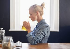 Woman Using Herbal Solutions and Drinking Tea to Calm Anxiety | Vitacost.com/blog