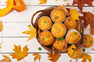 Pumpkin Cornbread Muffins in Bowl on White Background with Leaves | Vitacost.com/blog