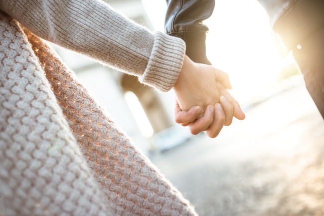 Couple Who Wants to Practice Gratitude Toward Each Other Hold Hands While Taking a Walk | Vitacost.com/blog