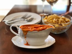 White Gravy Bowl of Roasted Carrot Sauce on Dinner Table With Pasta & Plates #recipe | Vitacost.com/blog
