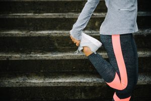Side View of Woman in Workout Attire Doing Best Stretches to Stay Flexible Over Age 40 | Vitacost.com/blog