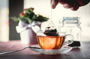 Tea Bag Being Dunked in Mug Representing Plastic Free Living Tips | Vitacost.com/blog