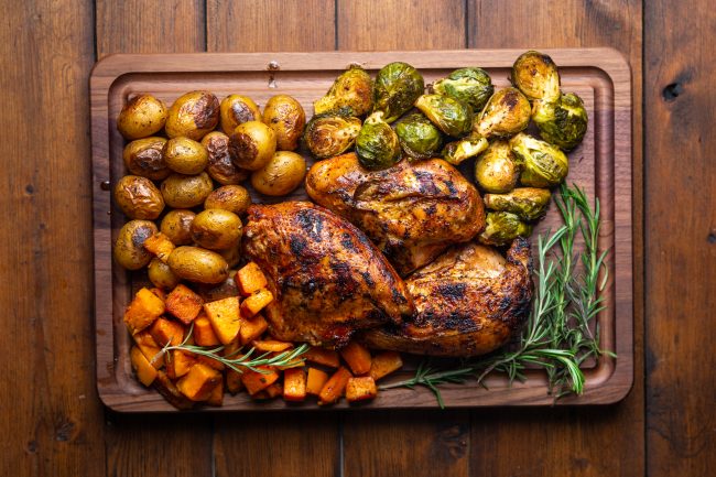 Smoked Chicken and Veggies with Rosemary on Wooden Cutting Board | Vitacost Blog