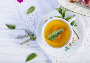 Mug of Peppermint Tea on Elegant Table Setting to Represent Benefits of Edible Plants | Vitacost.com/blog