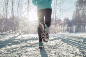 Woman Running Outdoors in Snow as Part of Modified Holiday Exercise Routine | Vitacost.com/blog