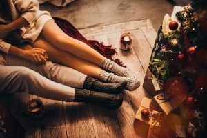 Couple Exchanging Plant-Based Gifts By Christmas Tree | Vitacost.com/Blog