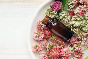 Amber Bottle in Bowl of Dried Flowers to Represent Most Popular Essential Oils and Their Uses | Vitacost.com/blog