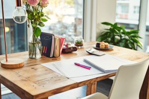 A Minimalist Home With a Tidy Desk Situated Behind Scenic Windows Overlooking City Street | Vitacost.com/blog
