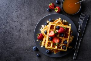 Top View of Waffles Sprinkled with Berries and Nut Shavings | Vitacost Blog