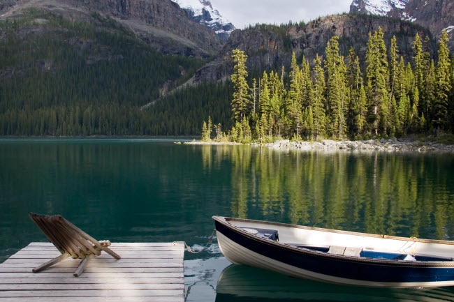 Serene Setting of Lake, Mountains and Forest with Dock and Boat in Foreground | Vitacost.com/blog