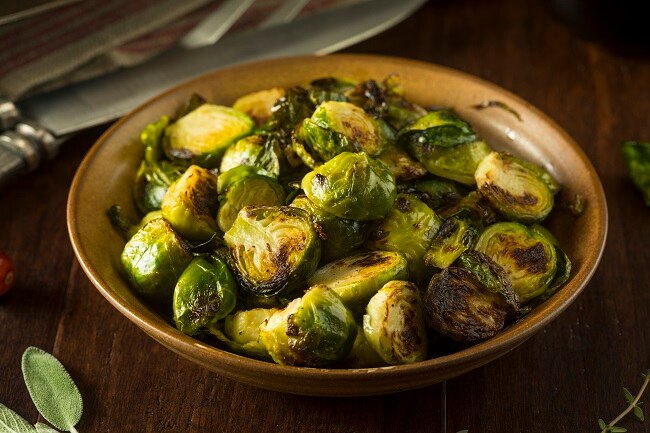 Lemon-Roasted Brussels Sprouts A Bunch of Roasted Brussels Sprouts in Brown Bowl | Vitacost.com/blog