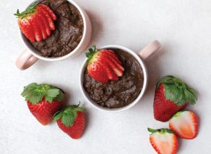 Collagen dark chocolate mousse in white mug with strawberries