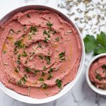 Roasted Beet Hummus in White Bowl with Parsley and Sunflower Seeds | Vitacost.com/blog