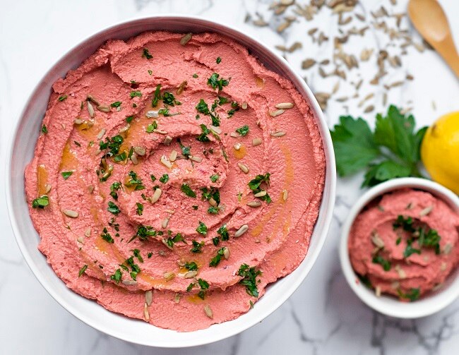 Roasted Beet Hummus in White Bowl with Parsley and Sunflower Seeds | Vitacost.com/blog