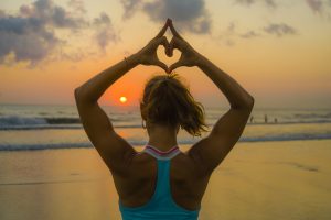 Woman Practicing Yoga with Hands in Heart Mudra to Symbolize Heart Health | Vitacost.com/Blog