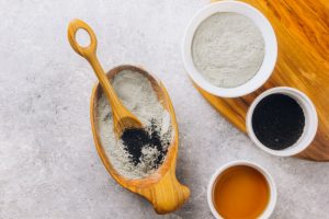Various Powdered Ingredients to Make DIY Charcoal Mask in Bowls on Gray Marbled Surface | Vitacost.com/blog