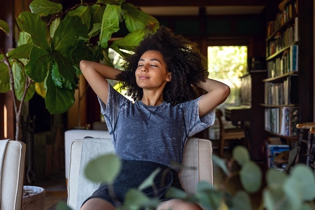 Woman on Couch Breathing in Purified Air at Home | Vitacost.com/Blog